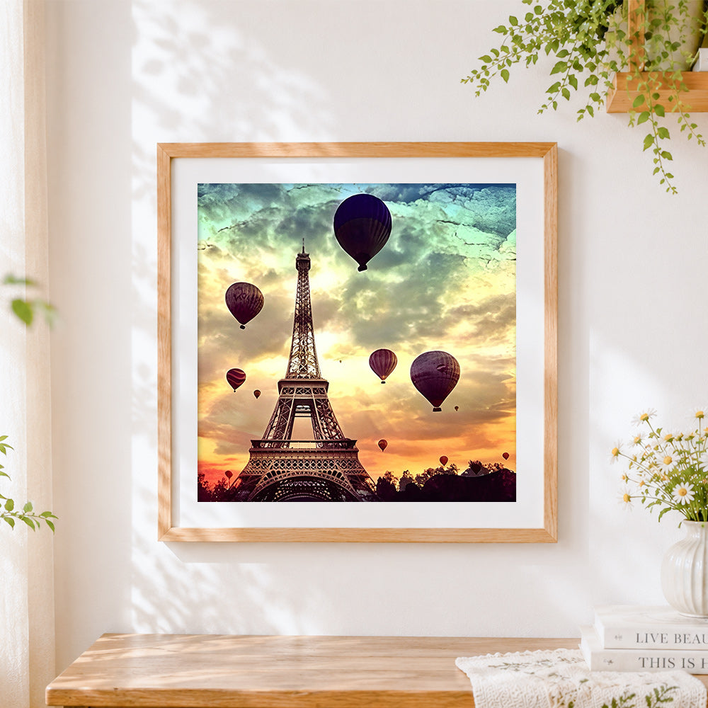 Finished eiffel tower and hot air balloons cross stitch artwork displayed