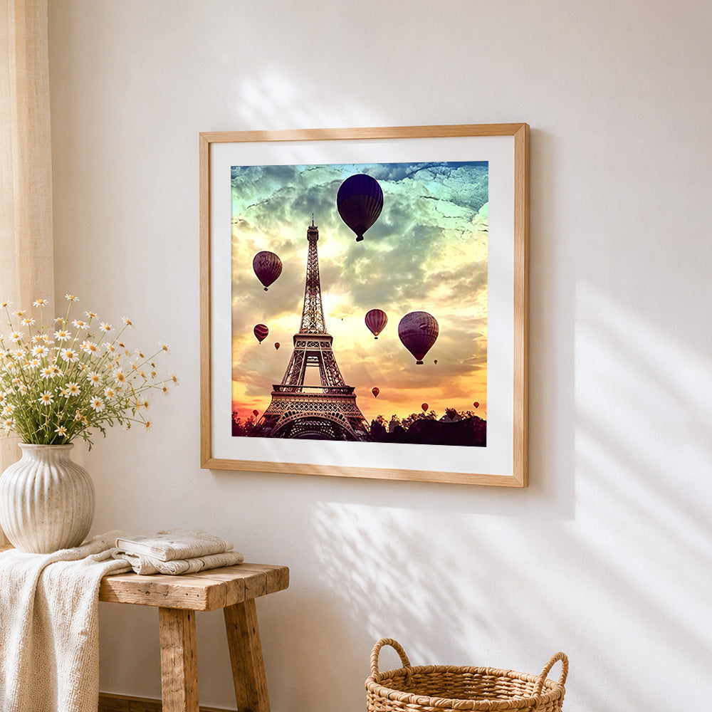 Eiffel tower and hot air balloons cross stitch artwork displayed on wall as home decor