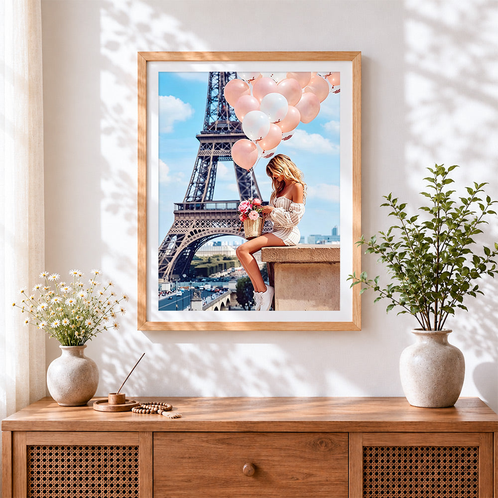 Finished eiffel tower and pink balloons cross stitch artwork displayed