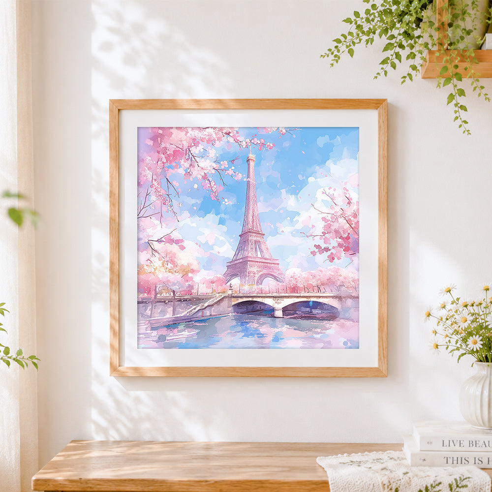 Finished eiffel tower in cherry blossom cross stitch artwork displayed