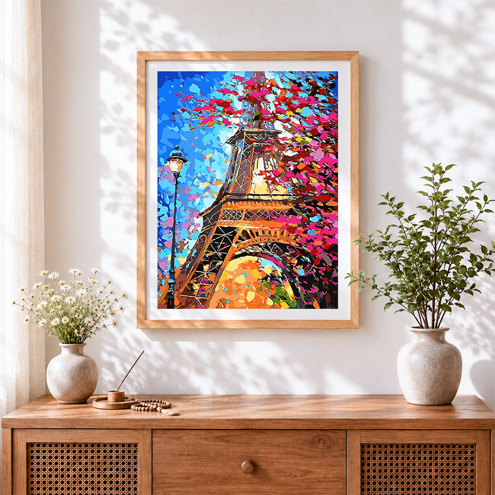 Finished eiffel tower through colourful leaves cross stitch artwork displayed