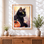 Finished elegant black cat with pumpkin cross stitch artwork displayed