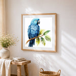 Elegant blue parrot on a branch cross stitch artwork displayed on wall as home decor