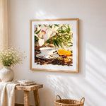 Elegant coffee cup with orchids cross stitch artwork displayed on wall as home decor