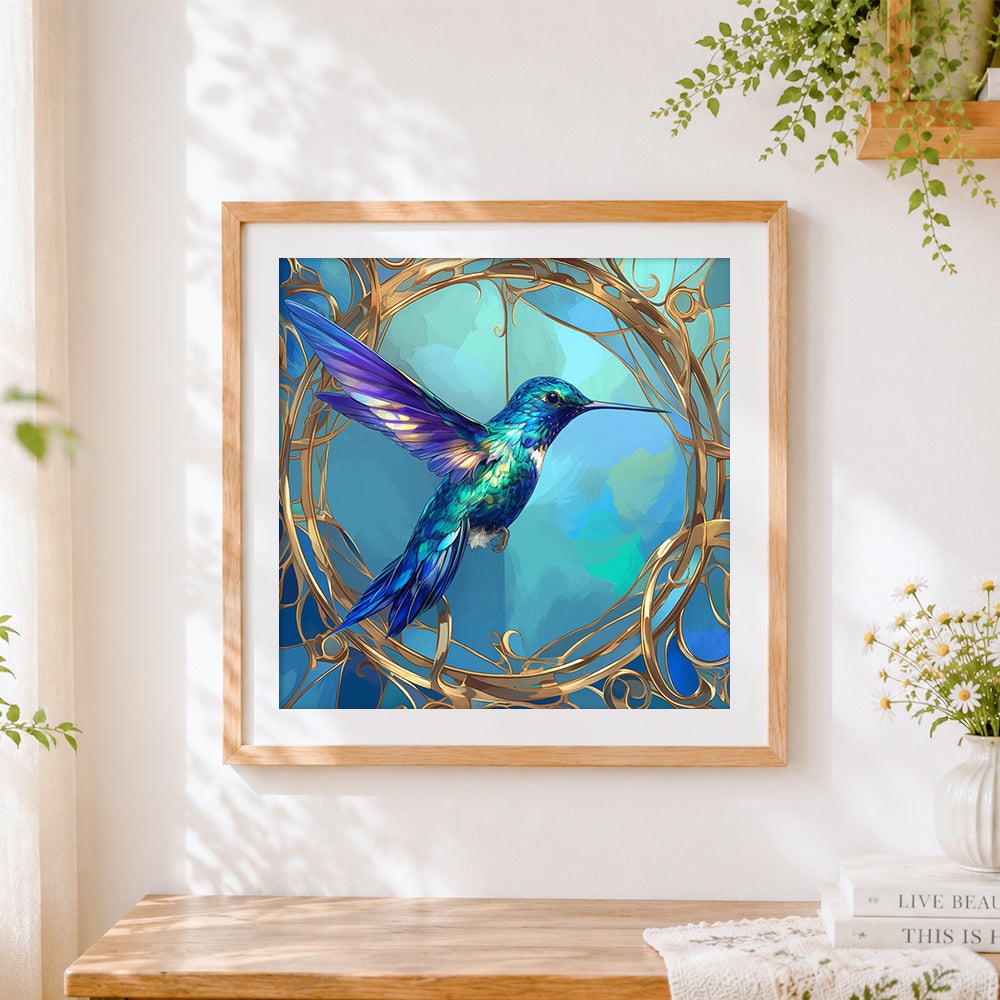 Finished elegant hummingbird in a gold frame cross stitch artwork displayed