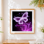 Finished elegant purple crystal butterfly cross stitch artwork displayed
