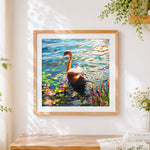 Finished elegant swan on water cross stitch artwork displayed
