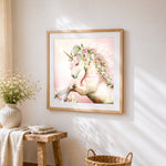 Elegant unicorn with floral crown cross stitch artwork displayed on wall as home decor