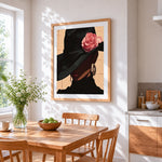 Elegant woman in black hat with rose cross stitch artwork displayed on wall as home decor