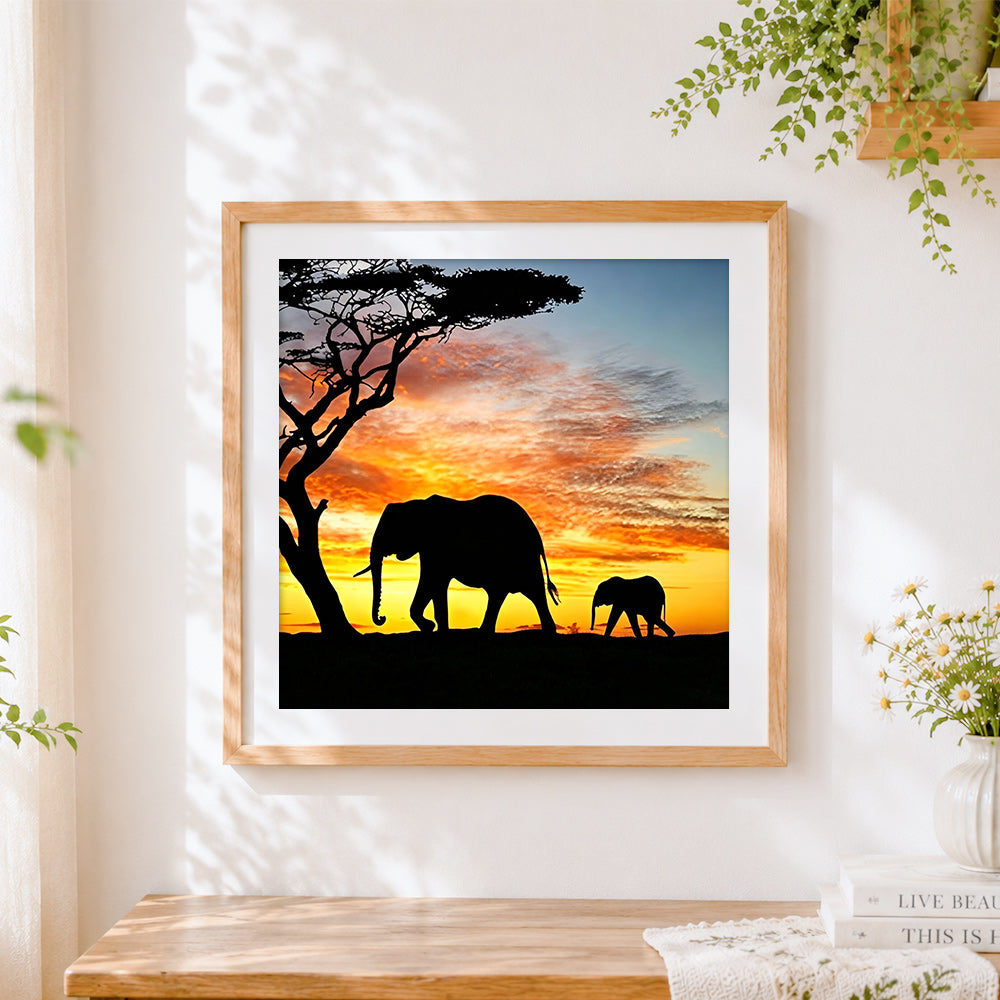 Finished elephant silhouette with acacia tree cross stitch artwork displayed