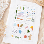 Embroidery practice fabric with beginner stitches, leaves, flowers and small decorative patterns