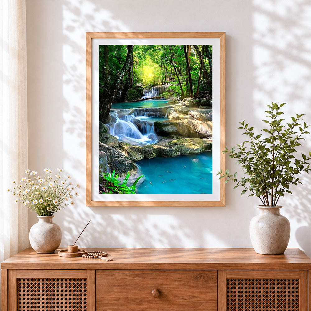 Finished enchanted forest waterfall cross stitch artwork displayed
