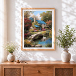 Finished english country cottage and swan cross stitch artwork displayed