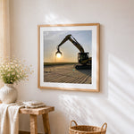 Excavator silhouette at sunset cross stitch artwork displayed on wall as home decor
