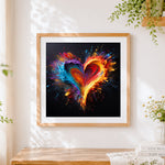 Finished exploding paint splatter heart cross stitch artwork displayed