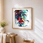 Expressionist portrait in bold colours cross stitch artwork displayed on wall as home decor