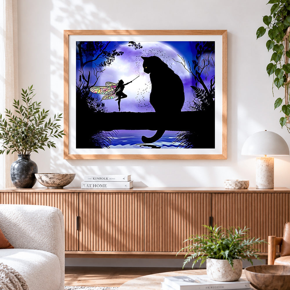 Finished fairy and black cat silhouette cross stitch artwork displayed