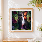 Finished fairy and giant black cat cross stitch artwork displayed