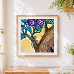 Finished fairy in a tree with purple flowers cross stitch artwork displayed