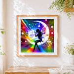 Finished fairy silhouette on rainbow moon cross stitch artwork displayed