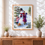 Finished family building snowman cross stitch artwork displayed