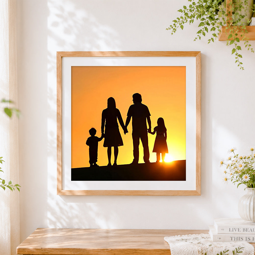 Finished family holding hands at sunset silhouette cross stitch artwork displayed
