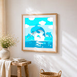 Family of dolphins jumping cross stitch artwork displayed on wall as home decor