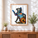 Finished fantasy cat and pumpkin cross stitch artwork displayed