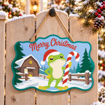Farmhouse frog holiday paint by numbers door hanger on a garden gate