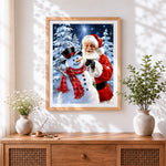 Finished father christmas and snowman in winter forest cross stitch artwork displayed