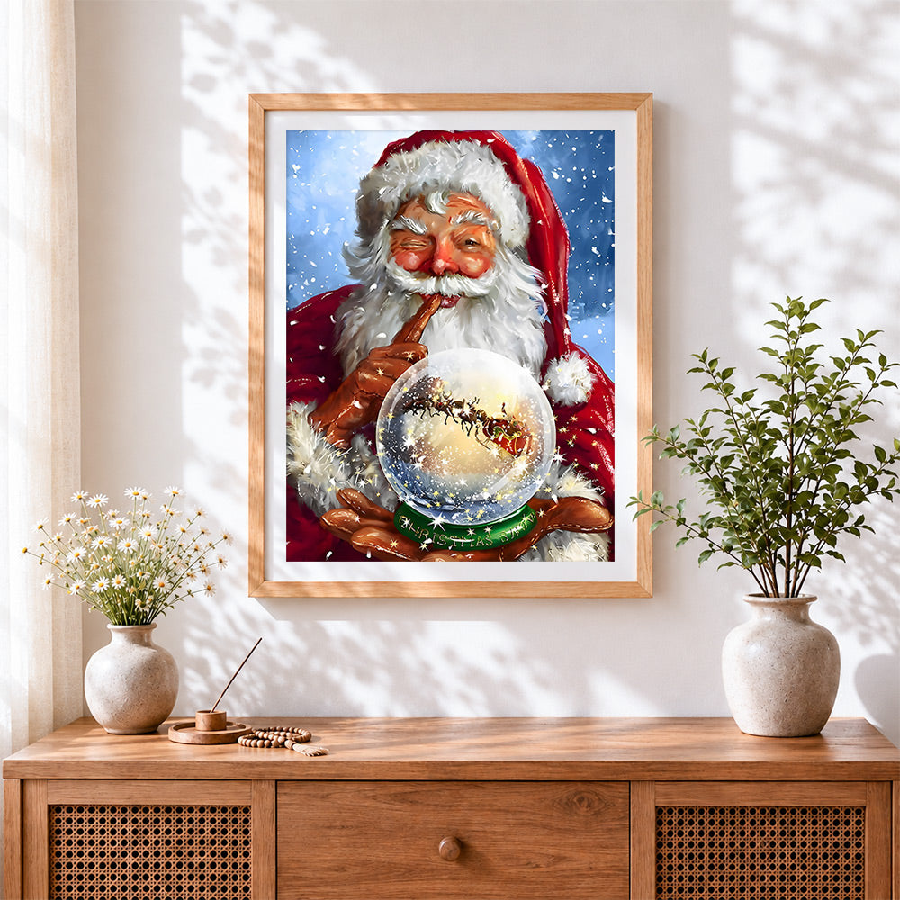Finished father christmas holding a magic snow globe cross stitch artwork displayed