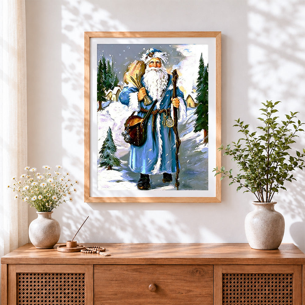Finished father christmas in blue robe in winter forest cross stitch artwork displayed