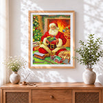 Finished father christmas playing with a toy train cross stitch artwork displayed
