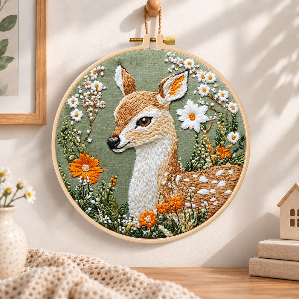 Fawn with daisies and orange blooms embroidery hoop wall art displayed as warm and cosy handmade home decor