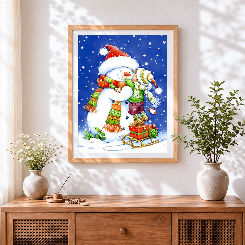 Finished festive child hugging a snowman cross stitch artwork displayed