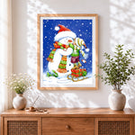 Finished festive child hugging a snowman cross stitch artwork displayed