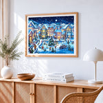 Festive christmas village at night cross stitch artwork displayed on wall as home decor