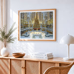 Festive city ice rink and giant christmas tree cross stitch artwork displayed on wall as home decor