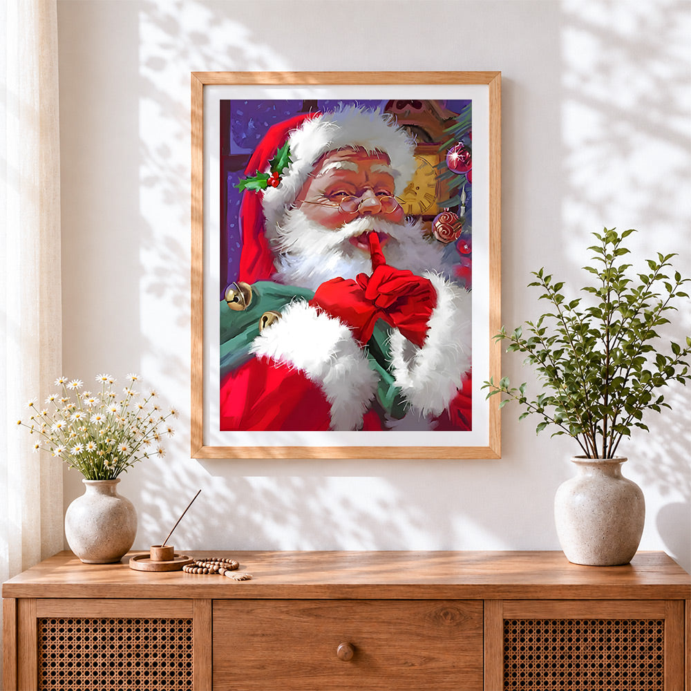 Finished festive father christmas going "shh!" cross stitch artwork displayed