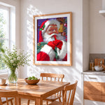 Festive father christmas going "shh!" cross stitch artwork displayed on wall as home decor