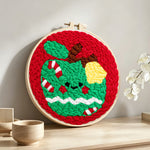 Festive green apple punch needle artwork displayed on a table