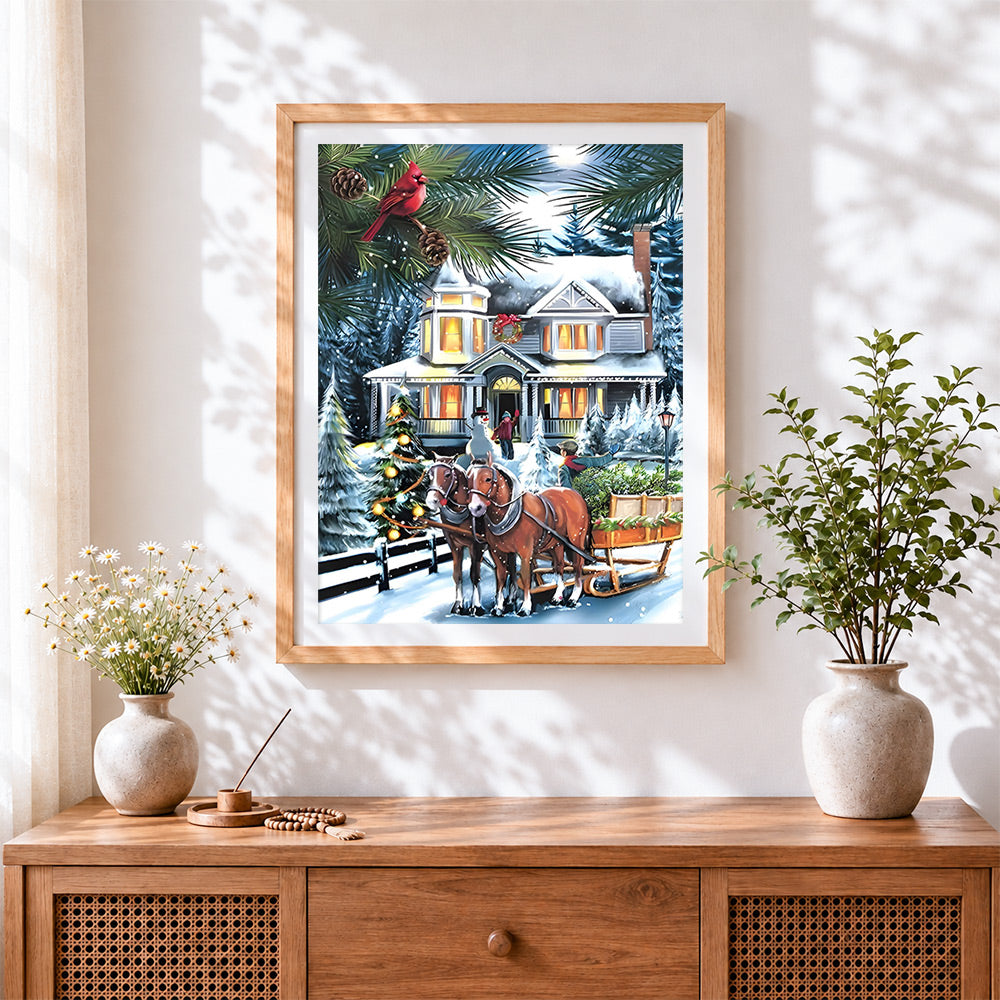 Finished festive horse-drawn sleigh by a snowy house cross stitch artwork displayed