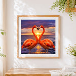 Finished flamingos forming a heart at sunset paint by numbers artwork displayed as home decor
