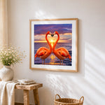 Flamingos forming a heart at sunset paint by numbers artwork displayed on wall as home decor