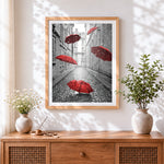 Finished floating red umbrellas cross stitch artwork displayed