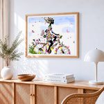 Floral bicycle woman silhouette cross stitch artwork displayed on wall as home decor