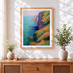 Finished floral coastal cliffs cross stitch artwork displayed