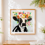 Finished floral crown cow cross stitch artwork displayed