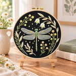 Floral dragonfly embroidery kit finished hoop displayed on a wooden stand as cosy tabletop decor