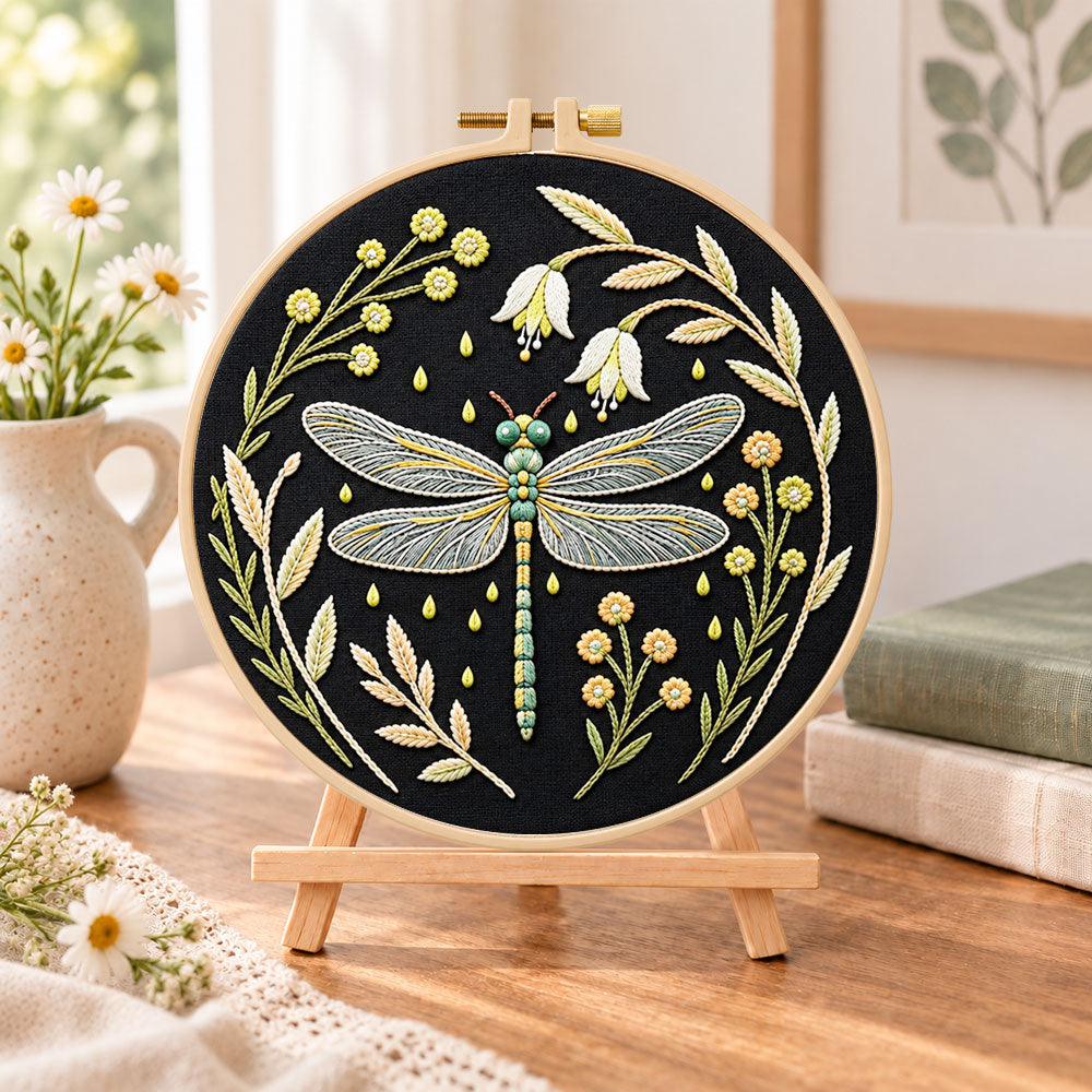 Floral dragonfly embroidery kit finished hoop displayed on a wooden stand as cosy tabletop decor
